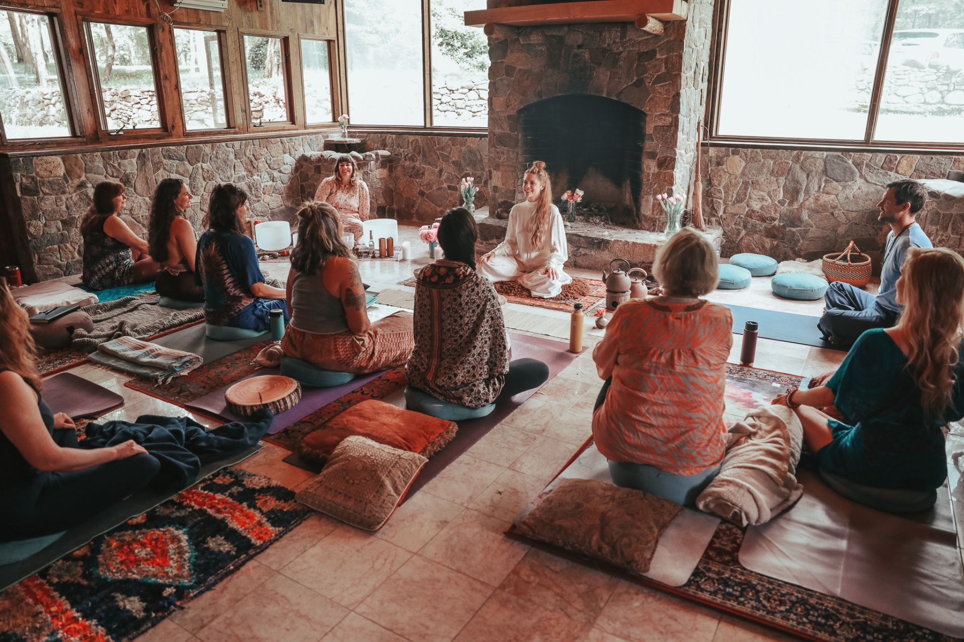 Group meditation circle by the fireplace