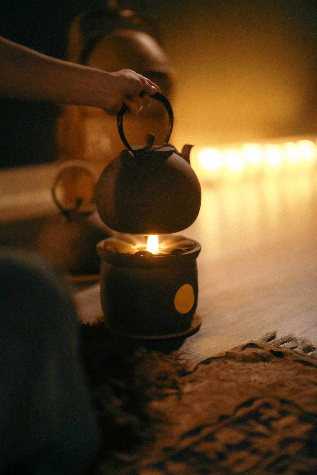 Tea kettle warmed over candlelight